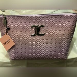 Juicy Couture iridescent zip up make up clutch with travel bottle included.